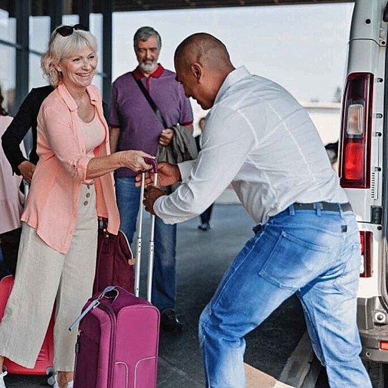 Friendly driver provides airport transfer guest pickup.